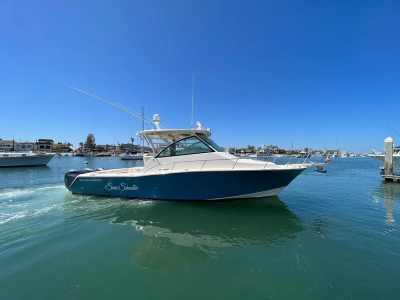 The Image of 2019 Grady-White Express 370 boat cruising in a sunny marina. - 1