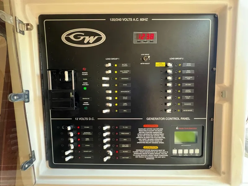 Slide: The Image of Grady-White Express 370 2019 electrical control panel with generator controls and voltage indicators. - 13