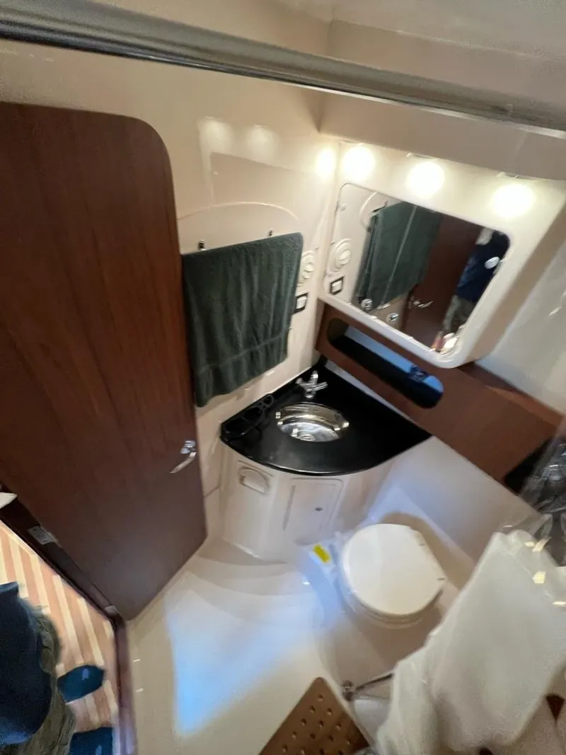 Slide: The Image of 2019 Grady-White Express 370 bathroom with sink, mirror, and toilet. - 16