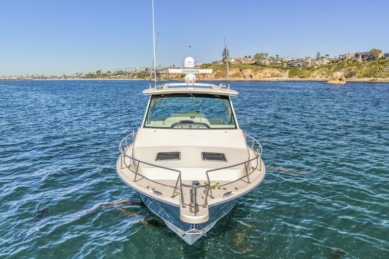 Slide: The Image of 2019 Grady-White Express 370 boat on open water, coastal background. - 24