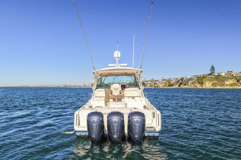 Slide: The Image of 2019 Grady-White Express 370 boat on open water, rear view with triple engines. - 27