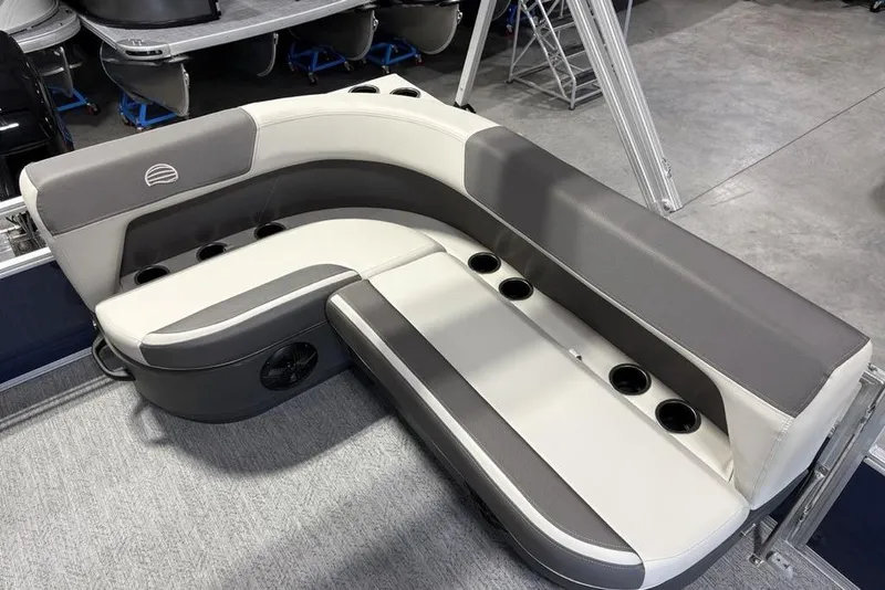 Slide: The Image of 2026 Sun Tracker Bass Buggy 16 XL Select boat seating with cup holders in showroom. - 19