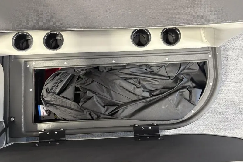 Slide: The Image of Storage compartment in 2026 Sun Tracker Bass Buggy 16 XL Select boat, featuring cup holders. - 17