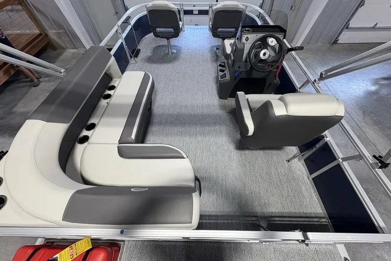 Slide: The Image of 2026 Sun Tracker Bass Buggy 16 XL Select pontoon boat interior with seating and steering console. - 16