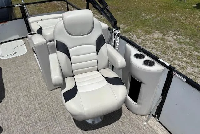 Slide: The Image of 2022 Sun Catcher 322 SS boat interior with plush captain's chair and cup holders. - 11