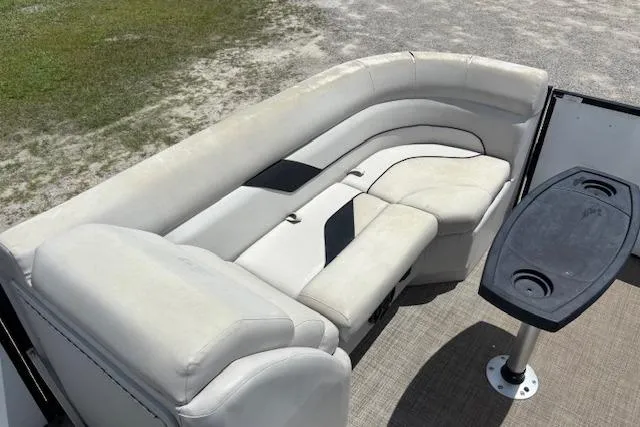 Slide: The Image of 2022 Sun Catcher 322 SS boat interior with white seating and a black table. - 14