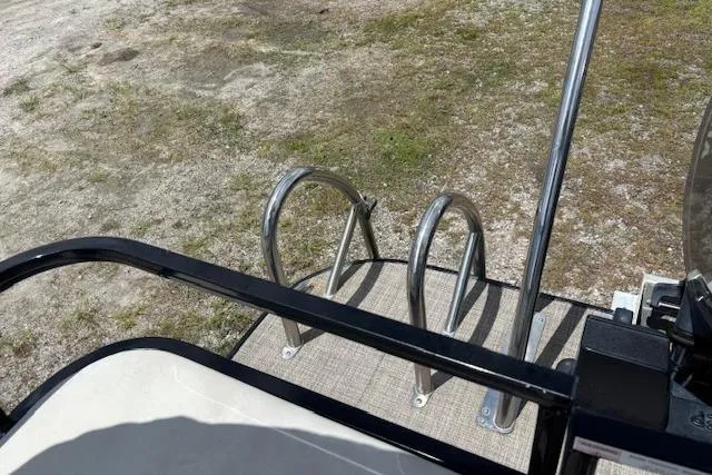 Slide: The Image of 2022 Sun Catcher 322 SS boat ladder and deck, shown on dry land. - 15