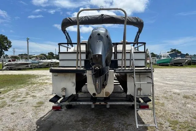 Slide: The Image of 2022 Sun Catcher 322 SS pontoon boat on trailer, rear view with outboard motor. - 5