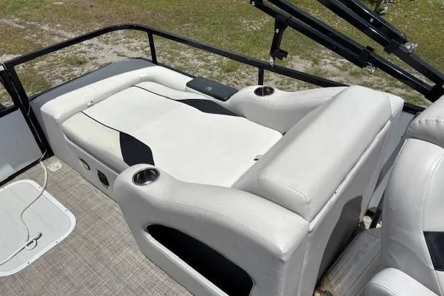 Slide: The Image of 2022 Sun Catcher 322 SS boat interior with cushioned seating and cup holders. - 9