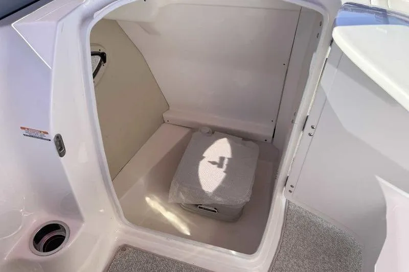 Slide: The Image of 2008 Chaparral 224 Extreme boat interior storage compartment with portable toilet. - 10