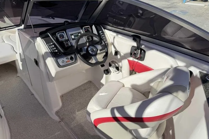 Slide: The Image of 2008 Chaparral 224 Extreme boat cockpit with steering wheel and control panel. - 11
