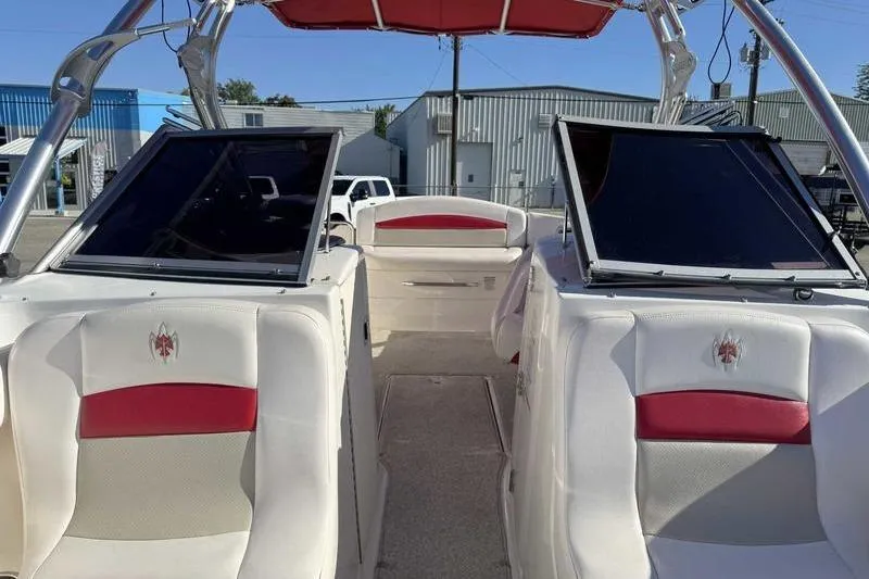 Slide: The Image of 2008 Chaparral 224 Extreme boat interior with white and red seating, open deck view. - 16