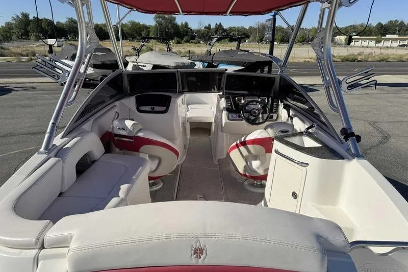 Slide: The Image of 2008 Chaparral 224 Extreme boat interior with red and white seating, steering console. - 4