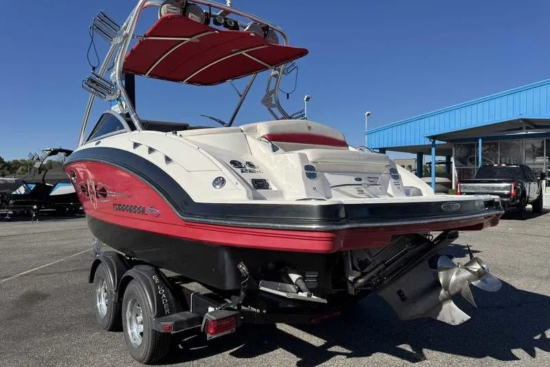 Slide: The Image of 2008 Chaparral 224 Extreme boat with red accents on a trailer, parked outdoors. - 7