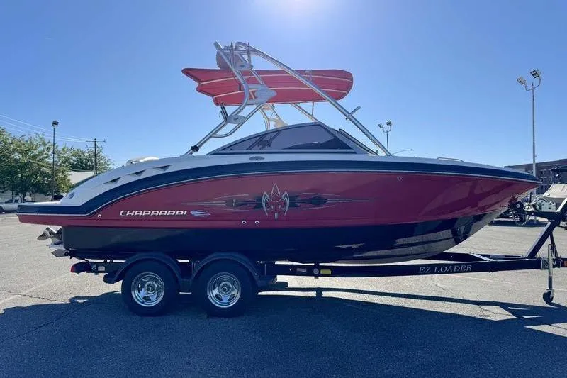 Slide: The Image of 2008 Chaparral 224 Extreme boat on trailer, red and black design, parked outdoors. - 9