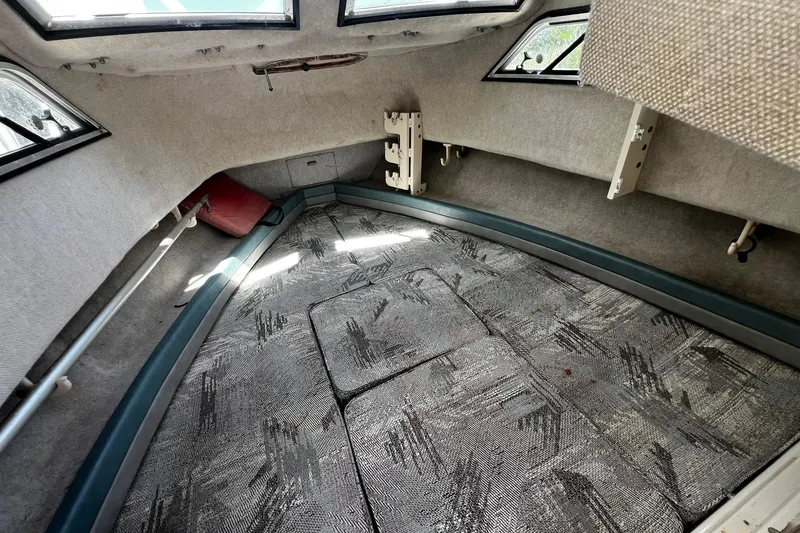 Slide: The Image of Interior cabin of 1992 Grady-White Explorer 244 boat with patterned cushions and windows. - 17