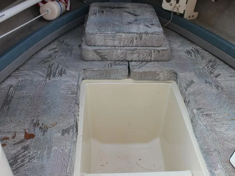 Slide: The Image of Interior of 1992 Grady-White Explorer 244 boat with cushioned seating and storage compartment. - 18