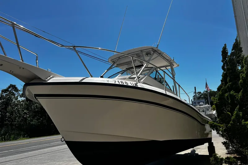 Slide: The Image of 1992 Grady-White Explorer 244 boat on display under clear blue sky. - 4