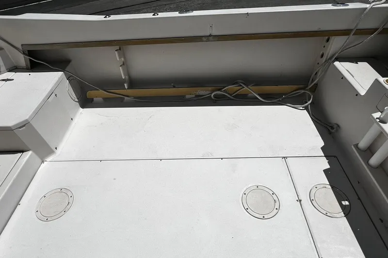 Slide: The Image of 1992 Grady-White Explorer 244 boat deck with storage compartments and clean layout. - 7