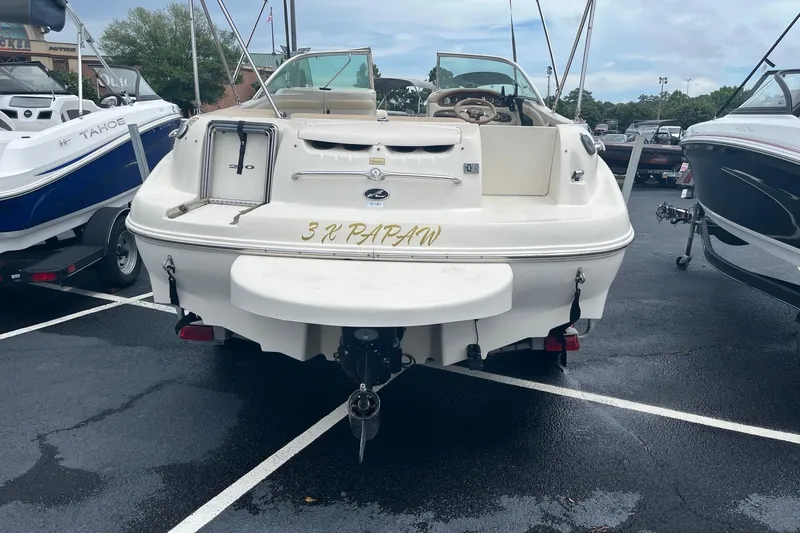 Slide: The Image of 2001 Sea Ray 210 Sundeck boat in parking lot, rear view. - 4