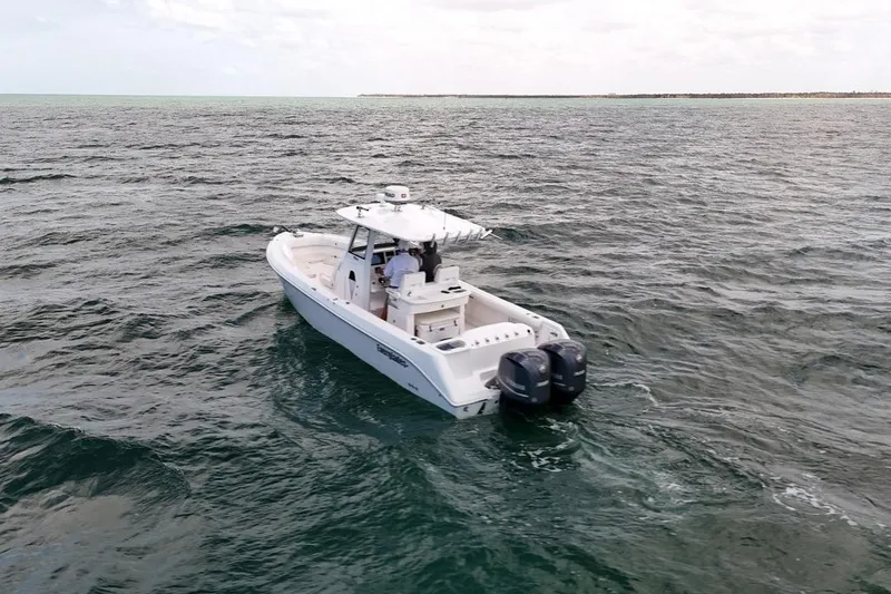 Slide: The Image of 2015 Everglades 295 Center Console boat cruising on open water. - 10