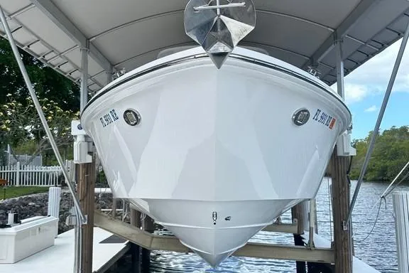 Slide: The Image of 2015 Everglades 295 Center Console boat docked under a canopy. - 12