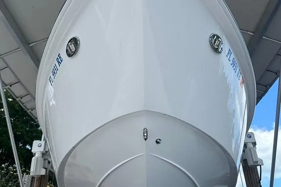 Slide: The Image of 2015 Everglades 295 Center Console boat, front view, docked under a canopy. - 14