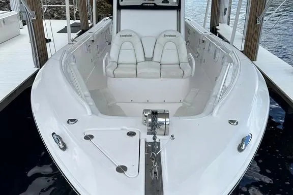 Slide: The Image of 2015 Everglades 295 Center Console boat docked, showcasing spacious seating and sleek design. - 15