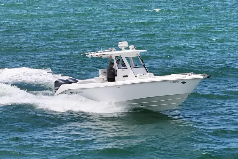 Slide: The Image of 2015 Everglades 295 Center Console boat cruising on open water. - 2