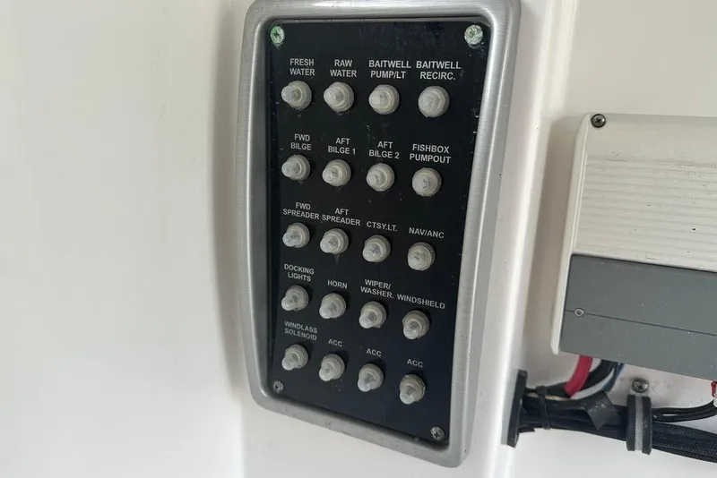 Slide: The Image of Control panel of a 2015 Everglades 295 Center Console boat with labeled switches. - 20