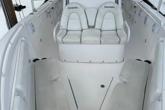 Slide: The Image of 2015 Everglades 295 Center Console boat interior with white seating and spacious layout. - 32