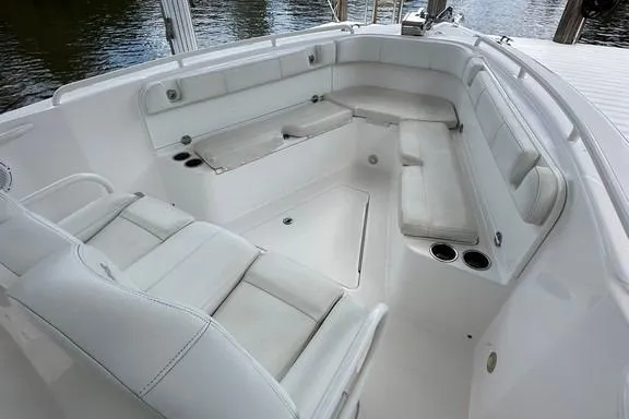 Slide: The Image of 2015 Everglades 295 Center Console boat with spacious white seating area. - 33