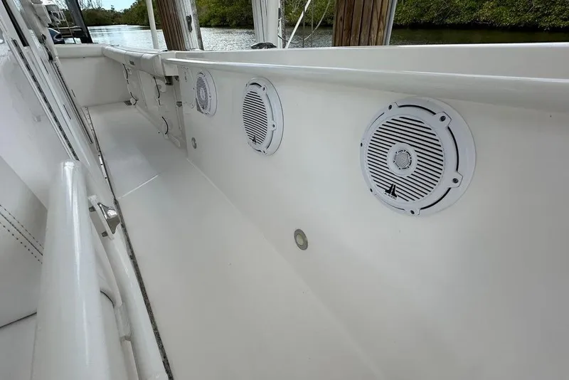 Slide: The Image of 2015 Everglades 295 Center Console boat interior with speakers and clean white finish. - 39