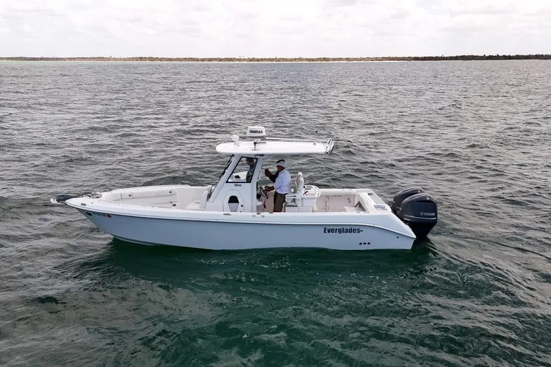 Slide: The Image of 2015 Everglades 295 Center Console boat cruising on open water. - 4