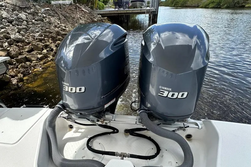 Slide: The Image of Twin Yamaha 300 engines on a 2015 Everglades 295 Center Console boat by the water. - 42