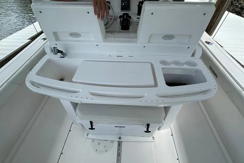 Slide: The Image of 2015 Everglades 295 Center Console boat interior with fishing station and storage. - 43