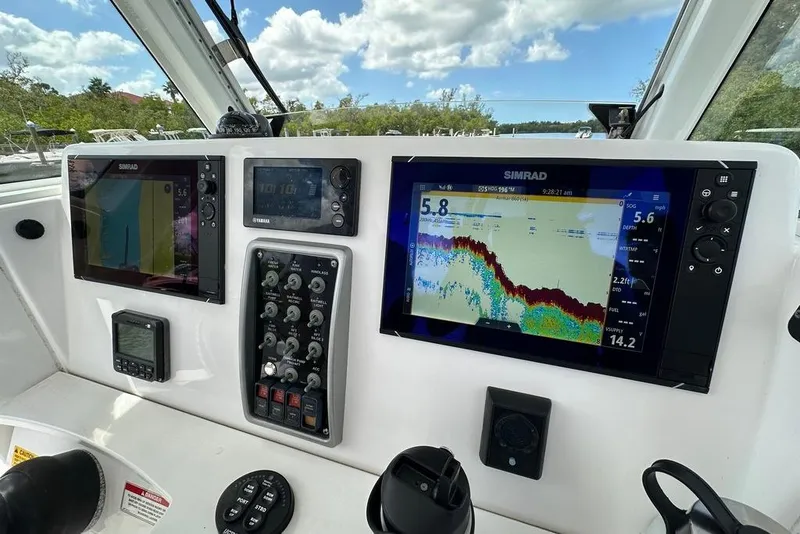 Slide: The Image of Control panel of 2015 Everglades 295 Center Console with Simrad displays and navigation equipment. - 52