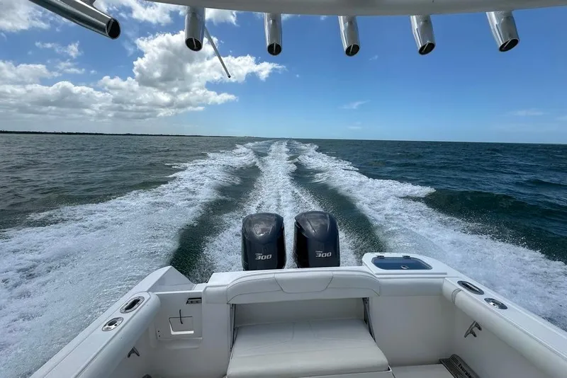 Slide: The Image of 2015 Everglades 295 Center Console boat cruising on open water, twin engines visible. - 53