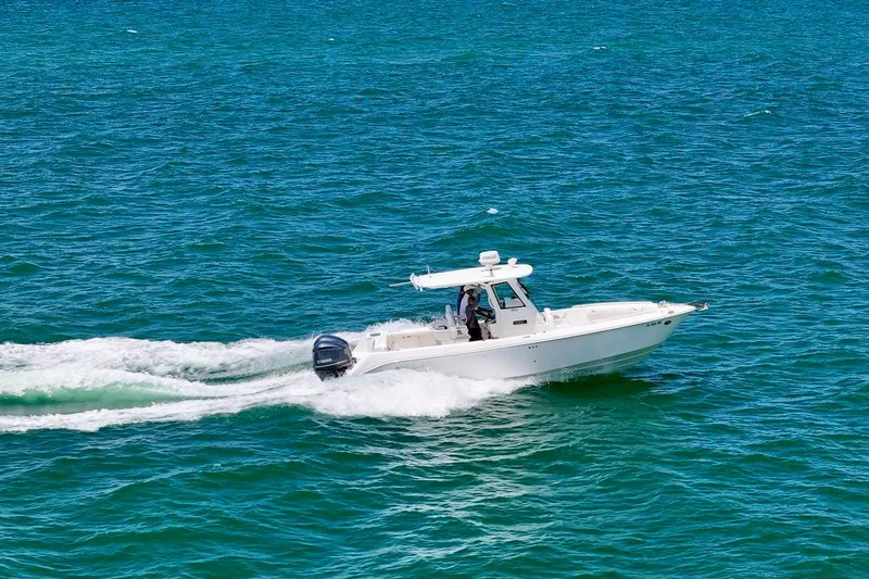 Slide: The Image of 2015 Everglades 295 Center Console boat cruising on open water. - 6