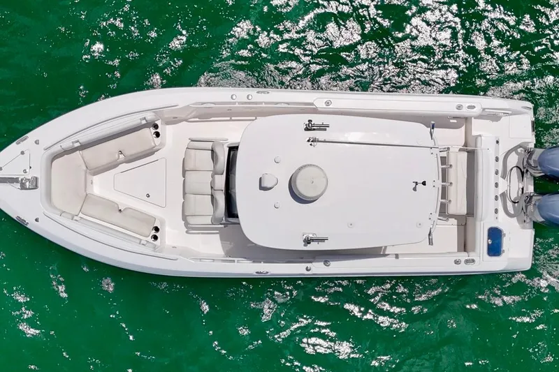 Slide: The Image of Overhead view of 2015 Everglades 295 Center Console boat on vibrant green water. - 7
