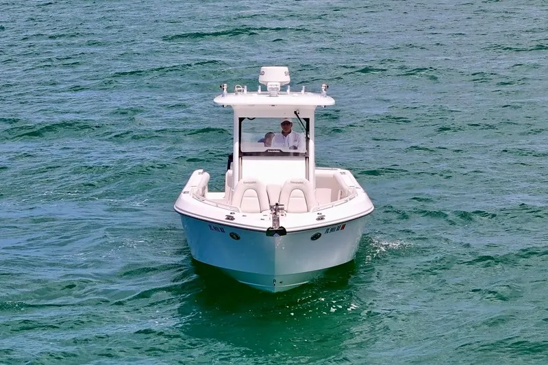 Slide: The Image of 2015 Everglades 295 Center Console boat navigating on clear blue water. - 8