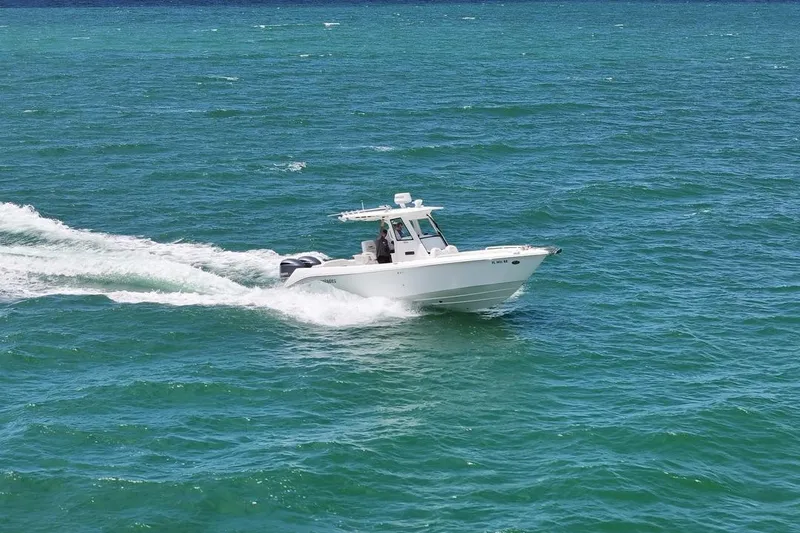 Slide: The Image of 2015 Everglades 295 Center Console boat cruising on open blue water. - 9