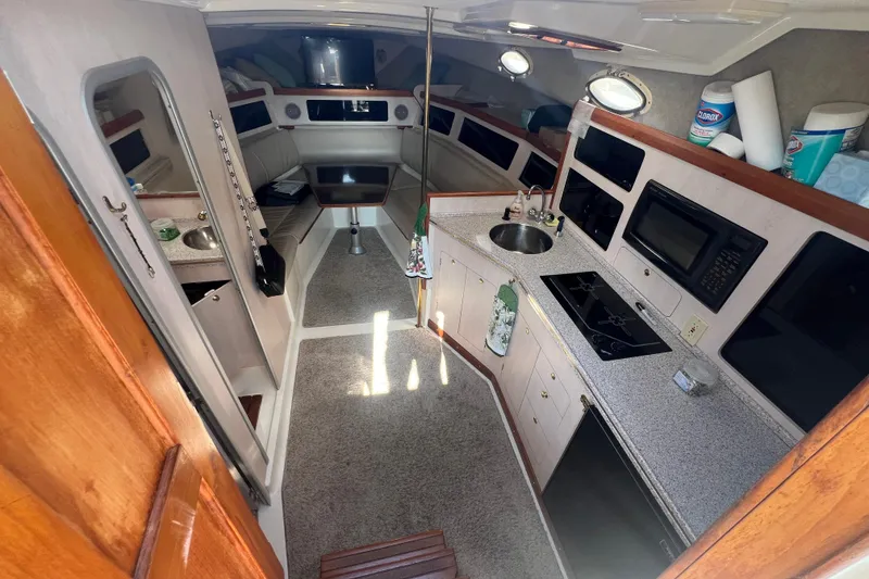 Slide: The Image of Interior of 1989 Luhrs 35 Alura boat with kitchen, seating, and modern amenities. - 11