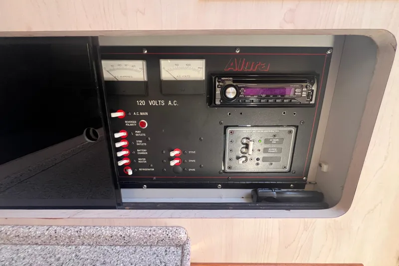 Slide: The Image of Electrical control panel of 1989 Luhrs 35 Alura boat with switches and gauges. - 18