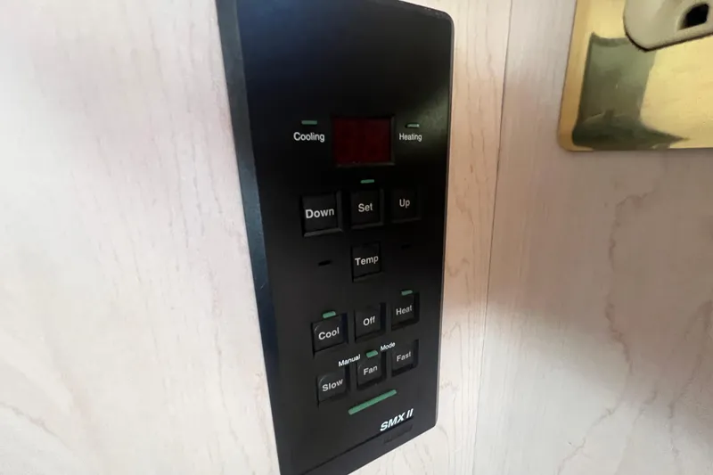 Slide: The Image of Control panel of a 1989 Luhrs 35 Alura boat, featuring cooling and heating options. - 20