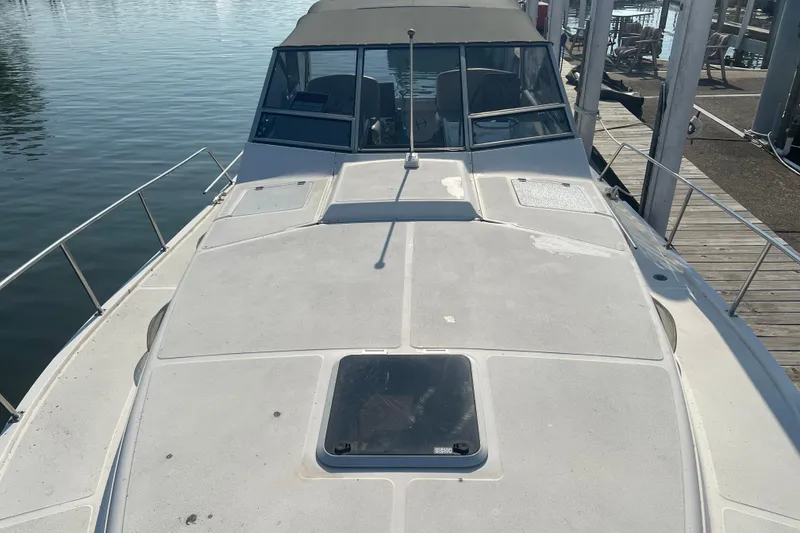 Slide: The Image of 1989 Luhrs 35 Alura boat docked, showcasing spacious deck and cabin area. - 22