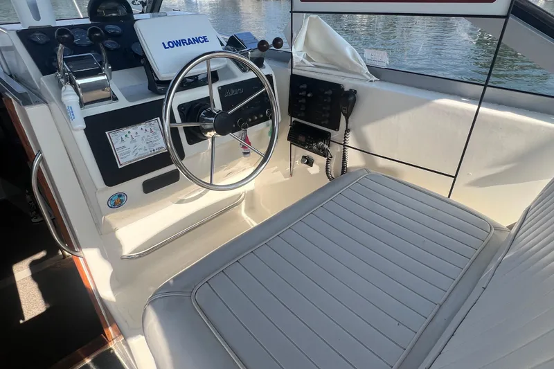 Slide: The Image of 1989 Luhrs 35 Alura boat cockpit with steering wheel and navigation equipment. - 6