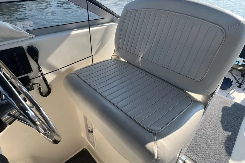 Slide: The Image of 1989 Luhrs 35 Alura boat interior with gray captain's seat and steering wheel. - 8