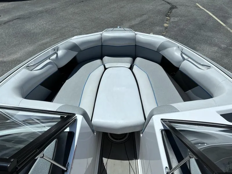 Slide: The Image of 2018 Moomba Mojo™ boat interior with gray seating and open windshield. - 2