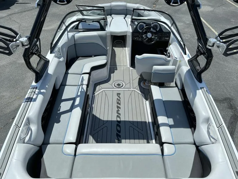 Slide: The Image of 2018 Moomba Mojo™ boat interior with gray seating and modern dashboard. - 7